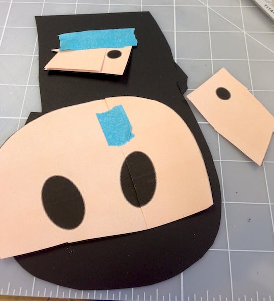 Cutting eyes and nose holes out of black cardstock