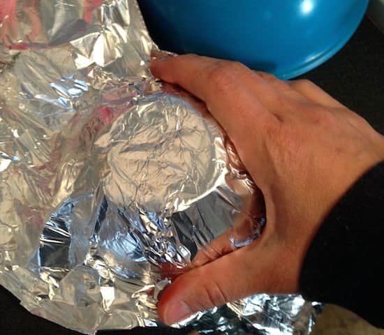 Wrapping aluminum foil around a bowl
