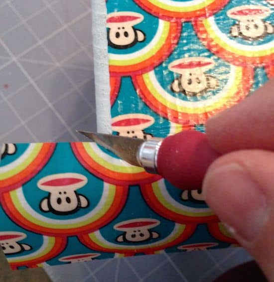Cutting the Paul Frank duct tape with a craft knife
