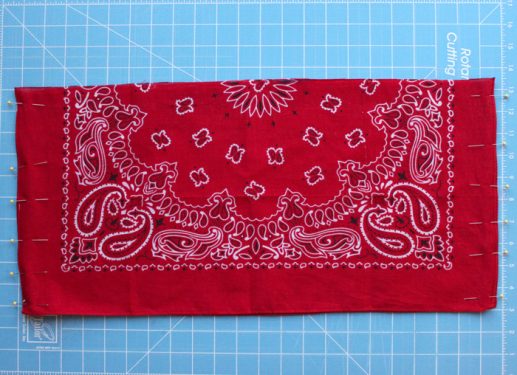 Two halves of a bandana pinned around the edges with straight pins