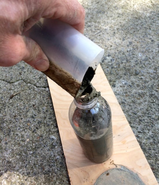 Pouring concrete into a plastic bottle