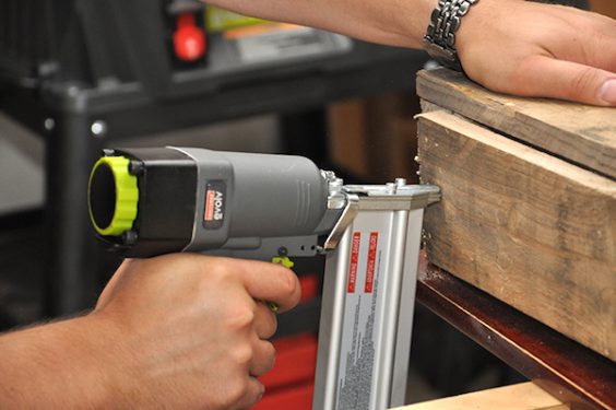 Nail gun attaching a piece of wood