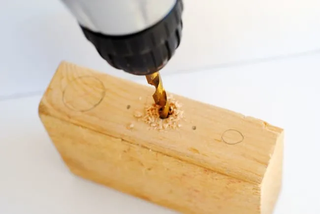 Drill holes into wood using a drill