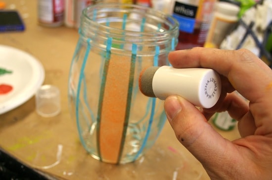 Painting a stencil tape striped jar with orange glass paint