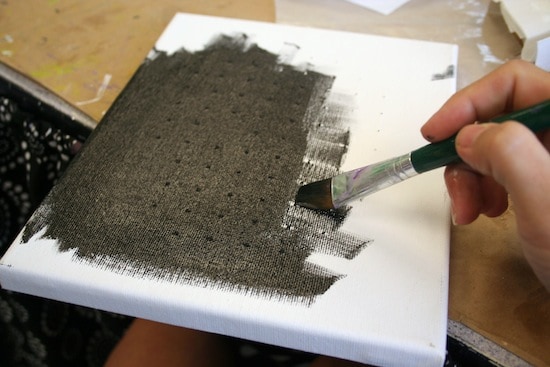 Painting a canvas with black craft paint