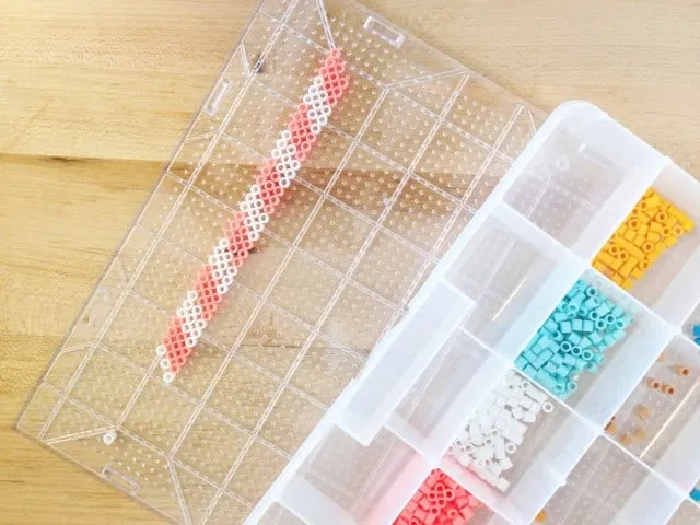 perler beads laid out on a pegboard about 8.5" long