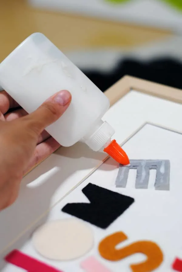 gluing felt letters to posterboard