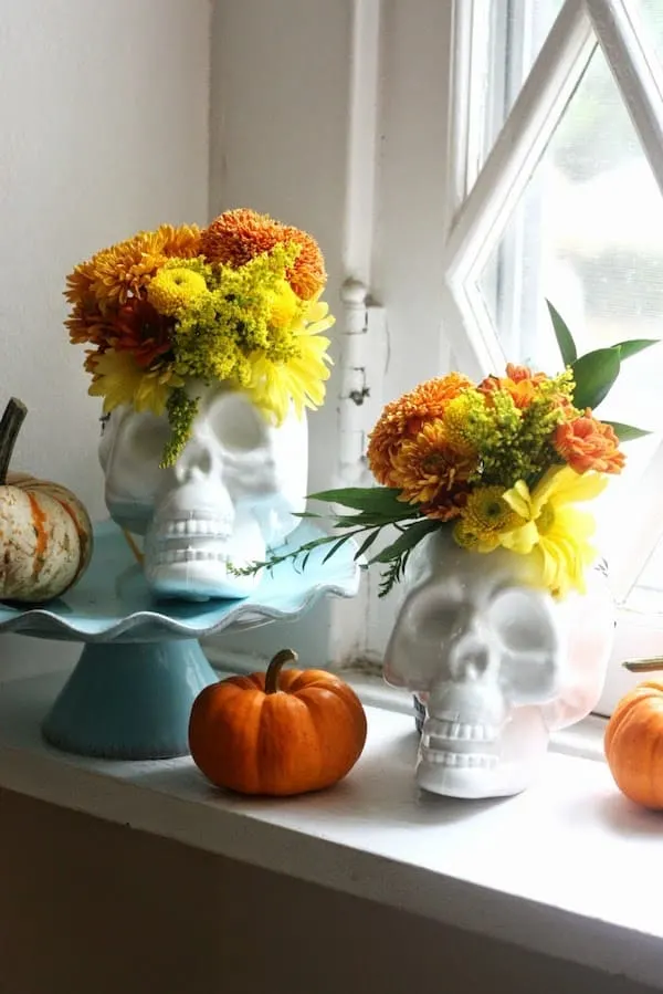 White painted skulls displayed with flowers
