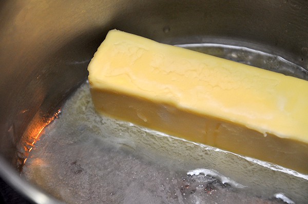 Stick of butter melting in a saucepan