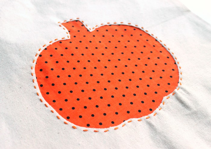 Pumpkin applique stitched around the edge with floss
