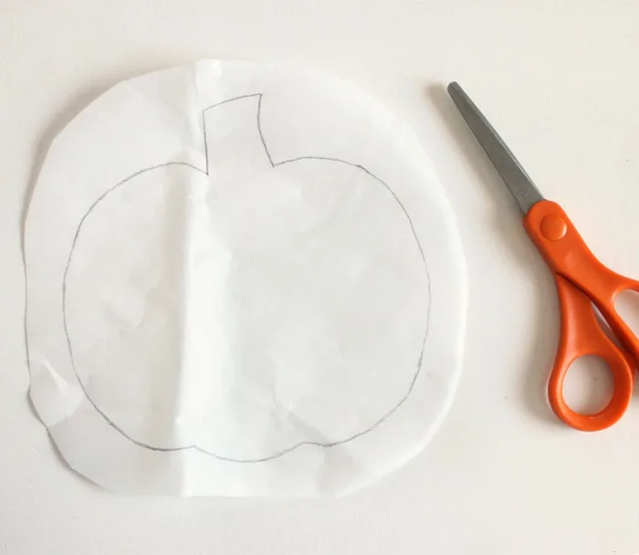 Cutting the pumpkin shape out with scissors