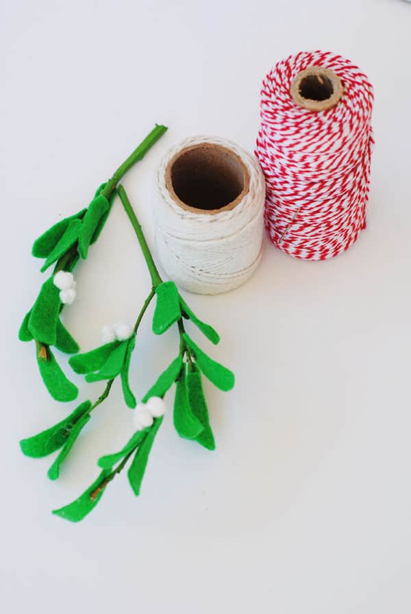 Red and white baker's twine, cotton thread, and felt mistletoe