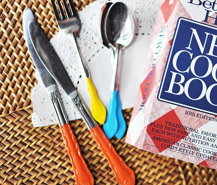 Spray painted utensils next to a cookbook