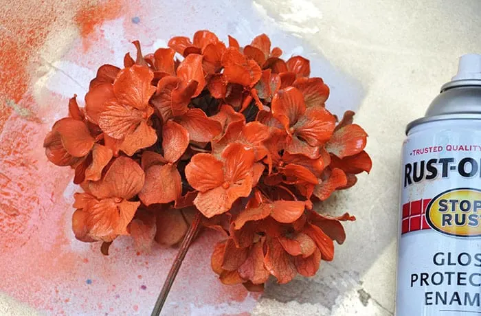 Spraying faux flowers with Rustoleum spray paint