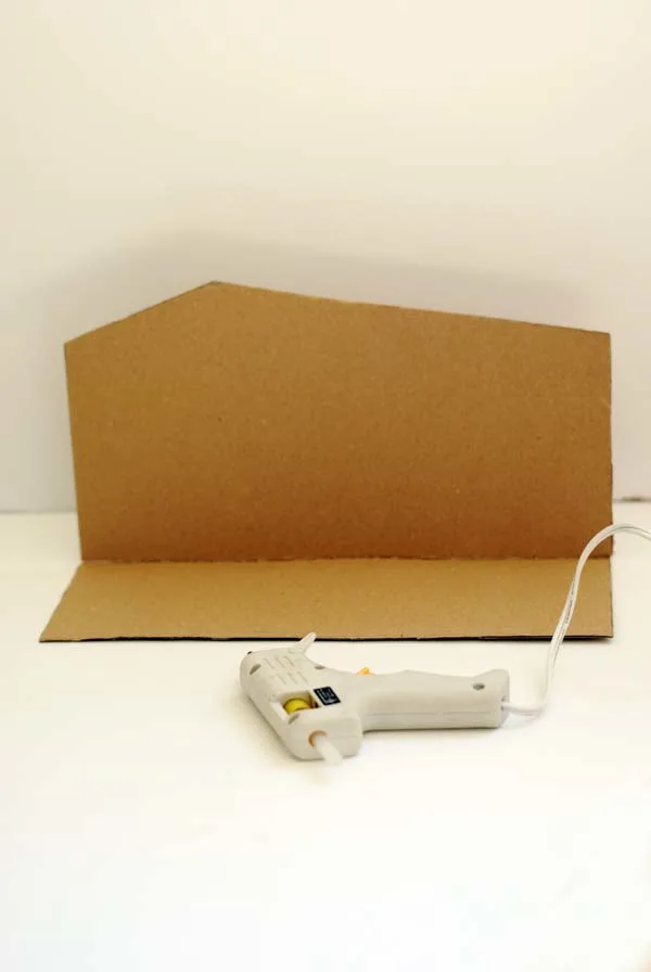 hot gluing cardboard into a barn shape
