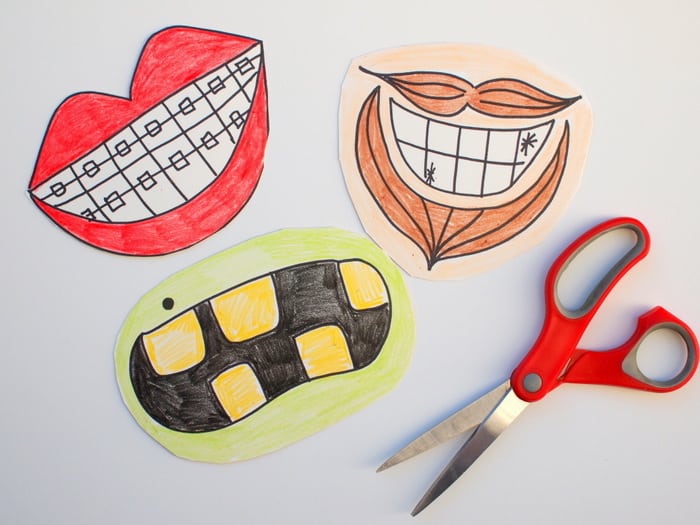 Mouth shapes cut out of paper plates with scissors