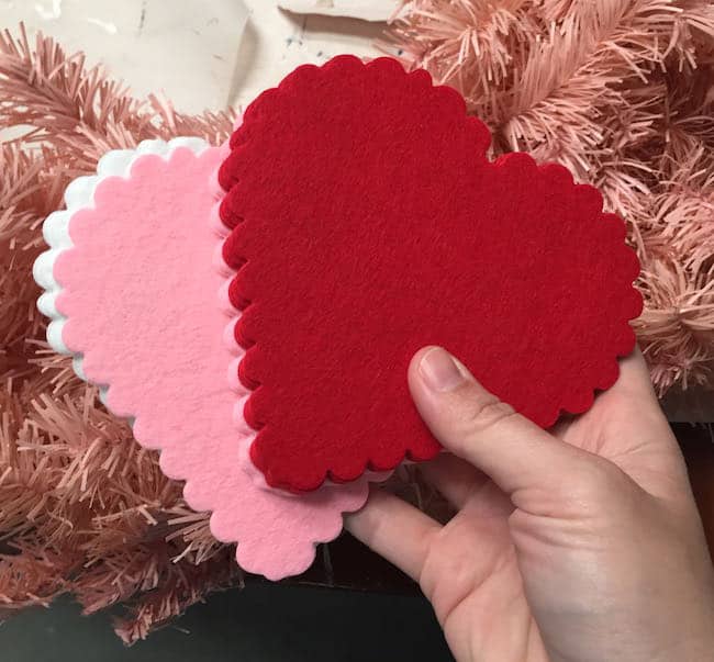 Hand holding a bunch of felt hearts