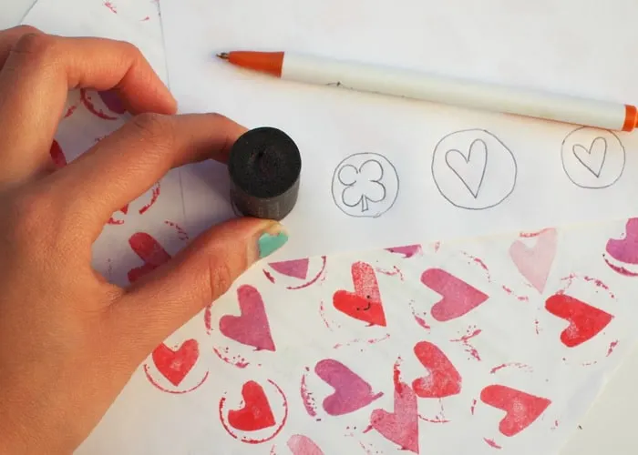 Wine cork being traced onto paper with a pen