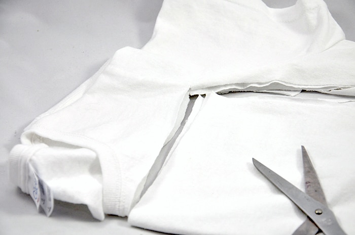 Section cut out of the middle of a white t-shirt with scissors