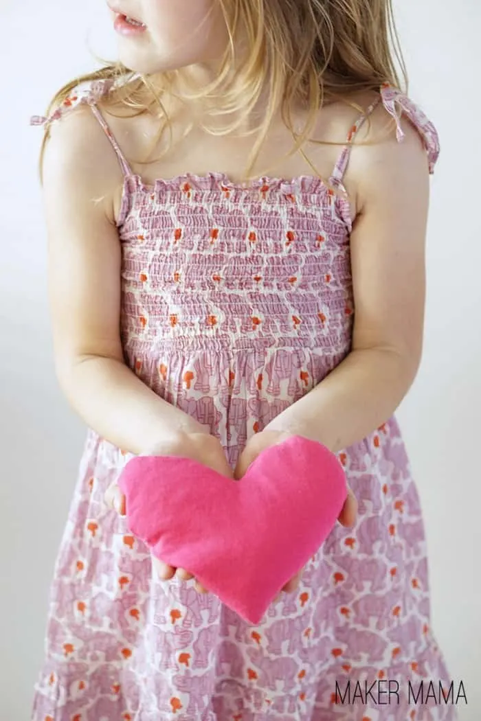 Girl holding a DIY hot pack shaped like a heart