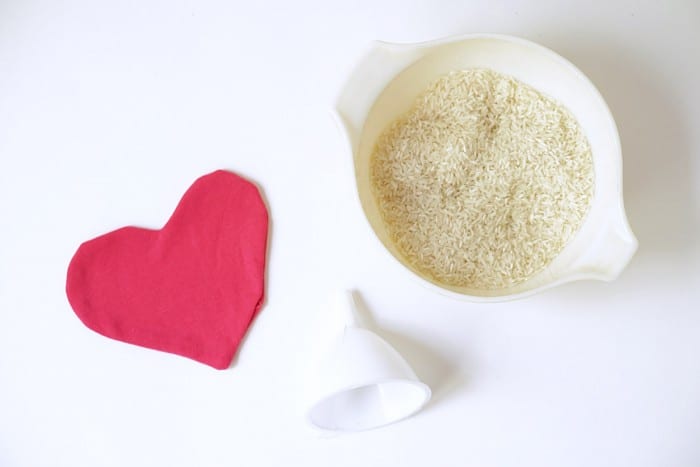 Heart hot and cold pack with rice and a funnel