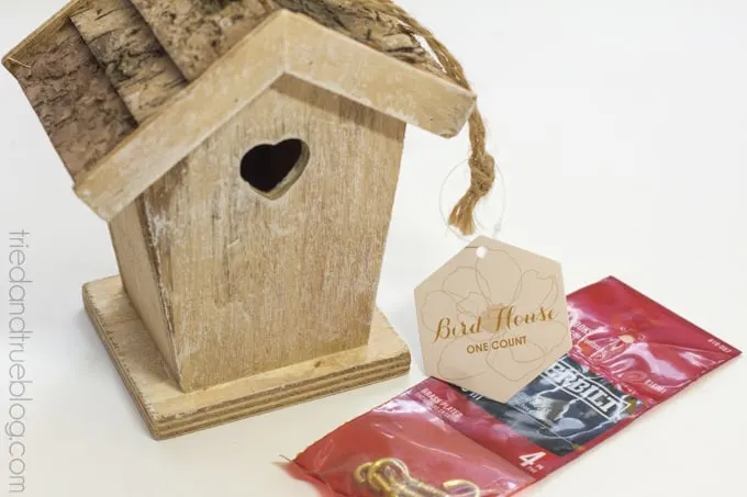 Wood birdhouse with a package of gold cup hooks