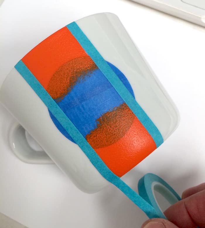 Second lines of painter's tape applied to the front of the mug