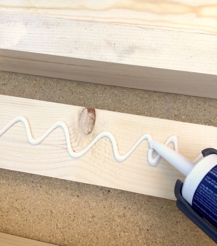 Applying Liquid Nails to a wooden pine board