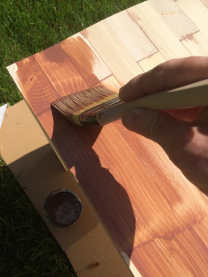 Painting Thompson's water seal onto a DIY wood bench