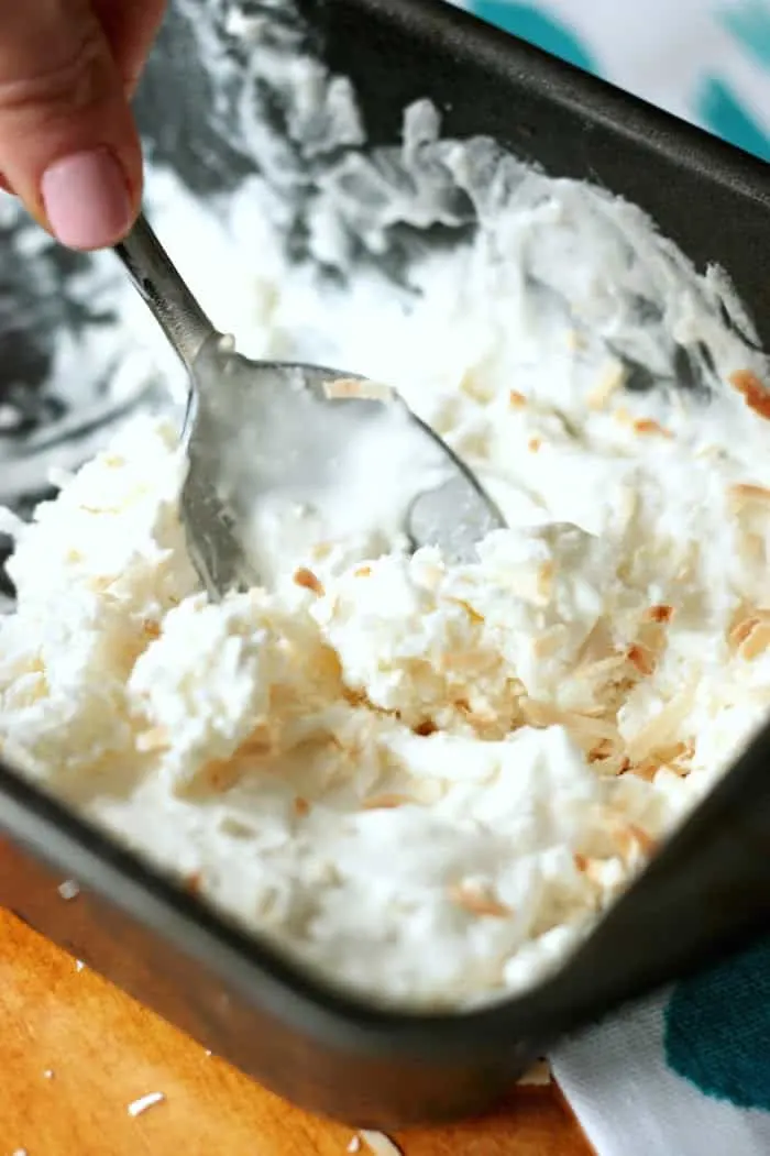 Taking a bite with a spoon of homemade coconut ice cream