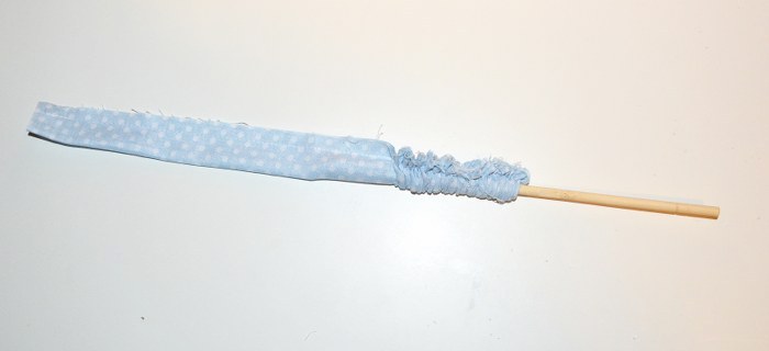 Pushing a dowel rod into a fabric tube