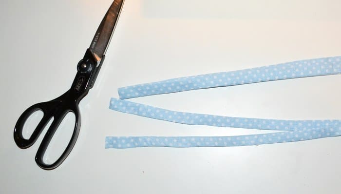 Cutting a tie in half with a pair of scissors