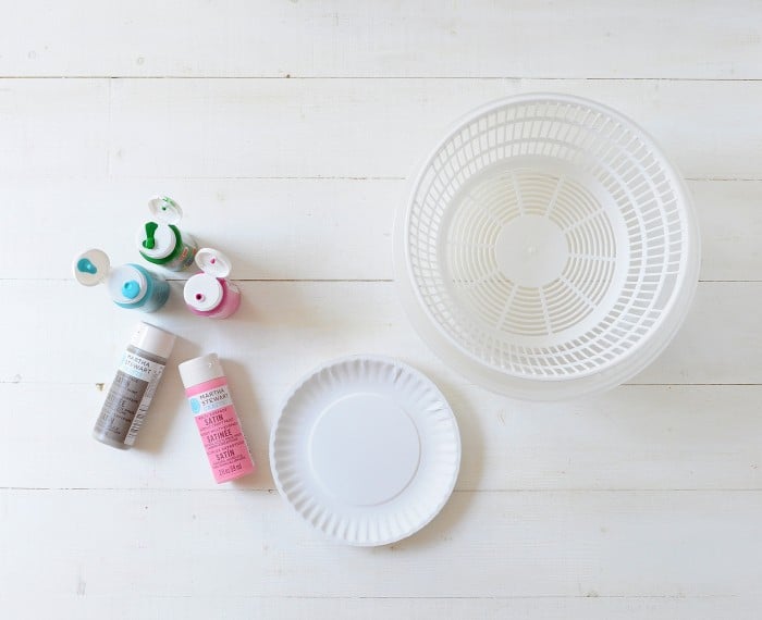Bottles of acrylic paint, a salad spinner, and paper plates