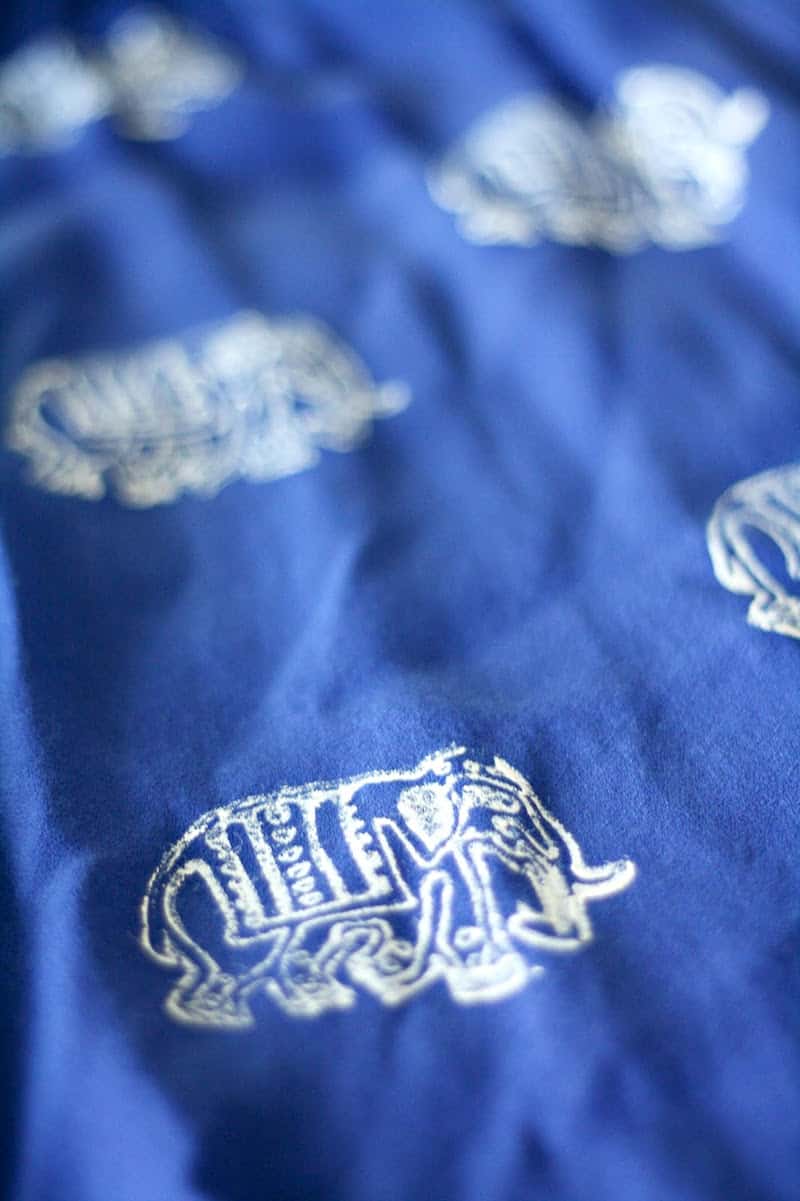 Elephant designs stamped onto a blue skirt with white fabric paint