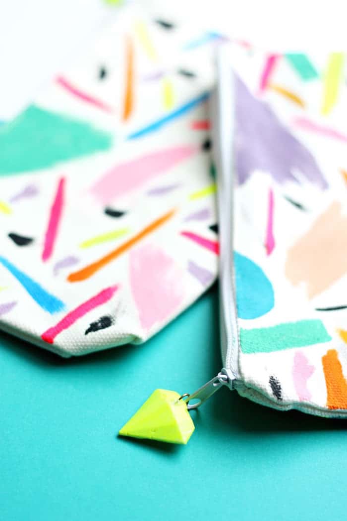 You don't need painting skills to create these beautiful abstract zipper pouches - with a custom DIY gem charm that you can make!