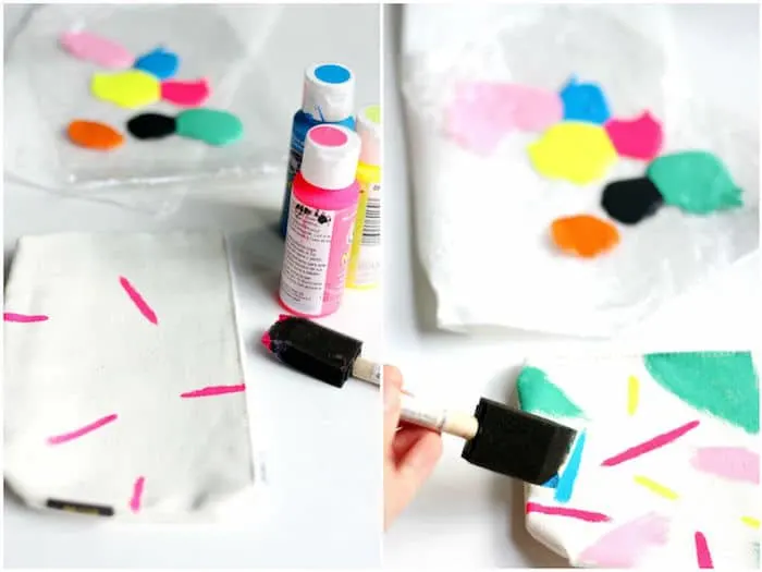 Applying paint marks to a canvas pouch with a foam brush