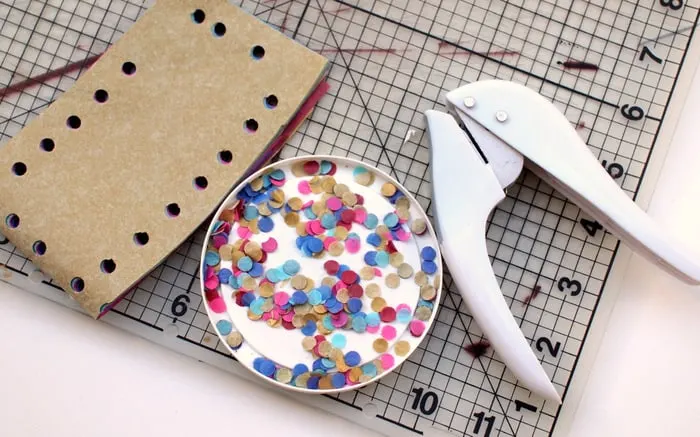 Making confetti with tissue paper and a hole punch