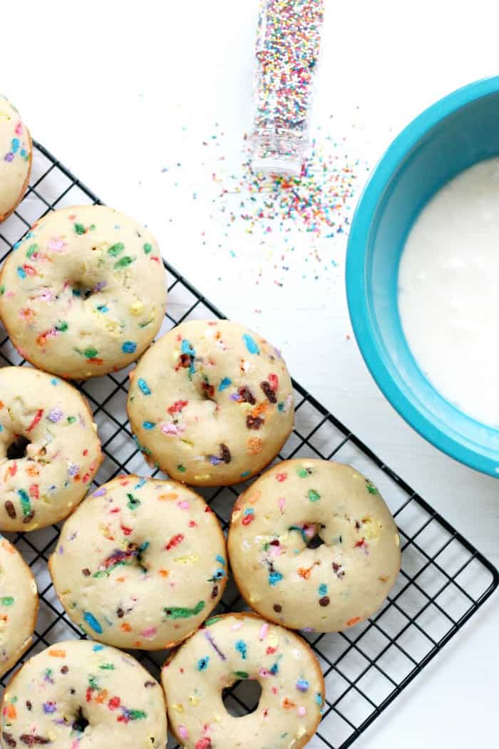 Funfetti donuts cooling on a baking rack