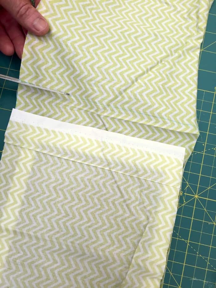 Creating the top flap of a DIY iPad case by taping and cutting with scissors