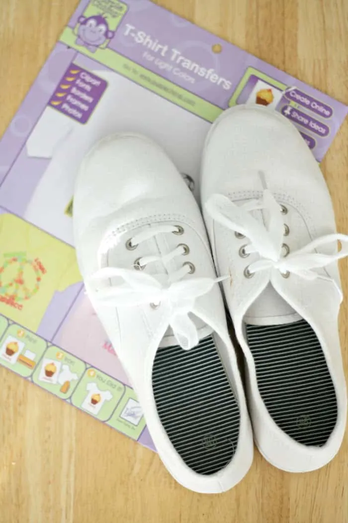White canvas sneakers and a pack of t-shirt transfers for light colors