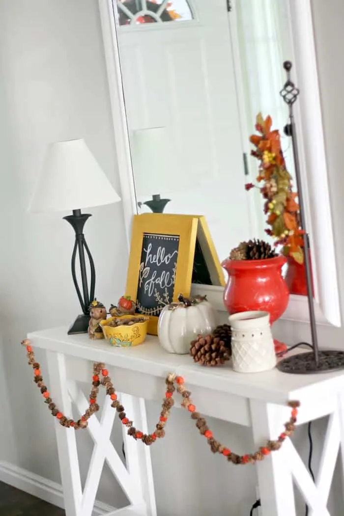 DIY autumn garland hanging on a white side table