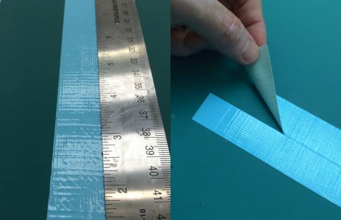 Trimming blue Duck Tape with a craft knife and ruler