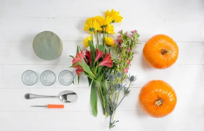 Pumpkins, glass votives, floral foam, spoon, pumpkin carving tool, and flowers