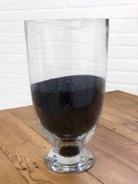 Decorative stone granules poured into an apothecary jar