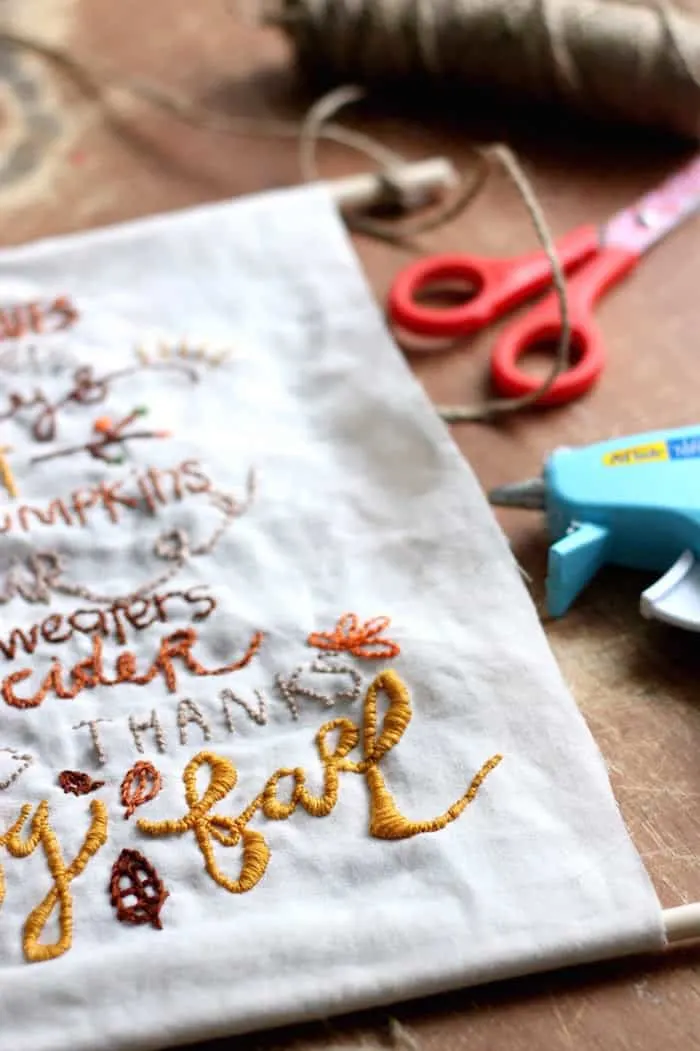 This pretty DIY wall hanging is embroidered with a fun fall theme! Our has a rustic touch but you can customize yours any way you like.