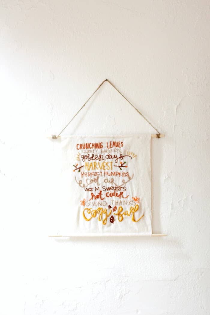 This pretty DIY wall hanging is embroidered with a fun fall theme! Our has a rustic touch but you can customize yours any way you like.