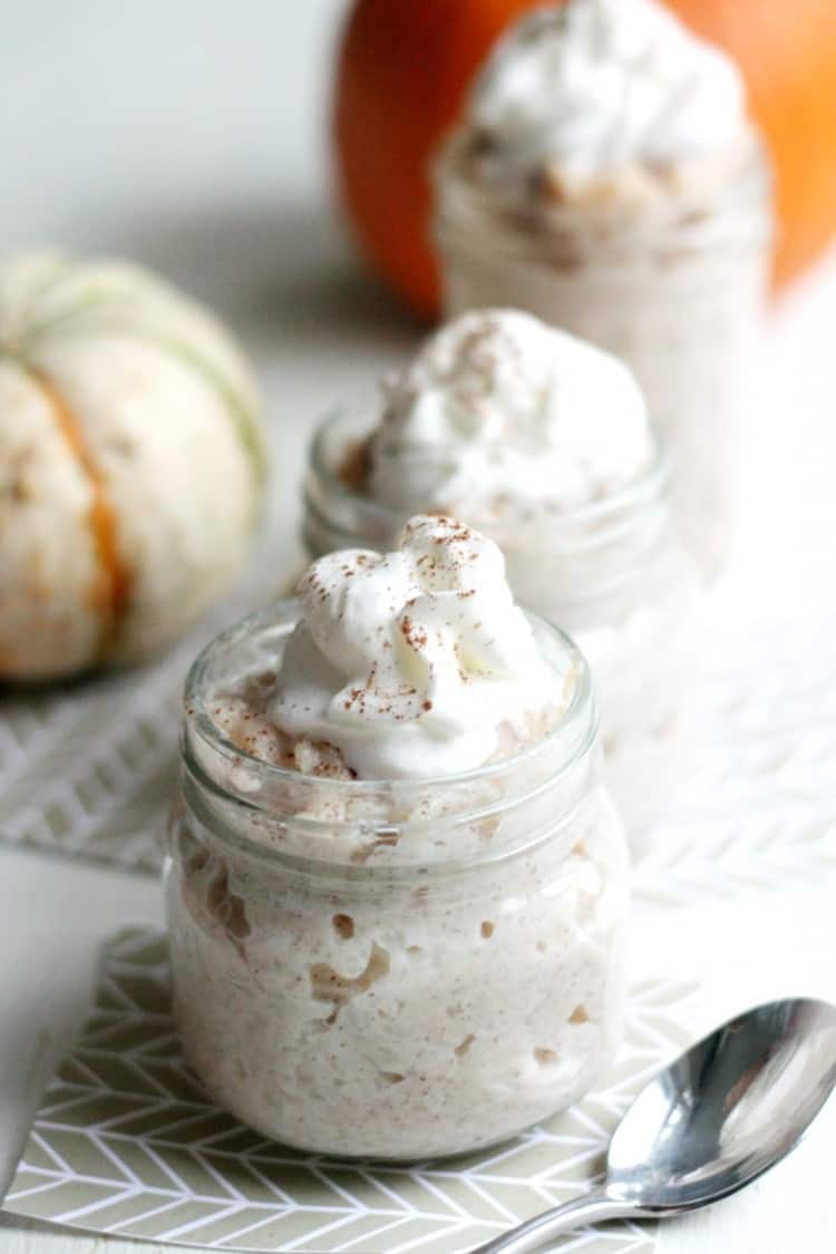 Slow cooker pumpkin rice pudding in a mason jar with a spoon
