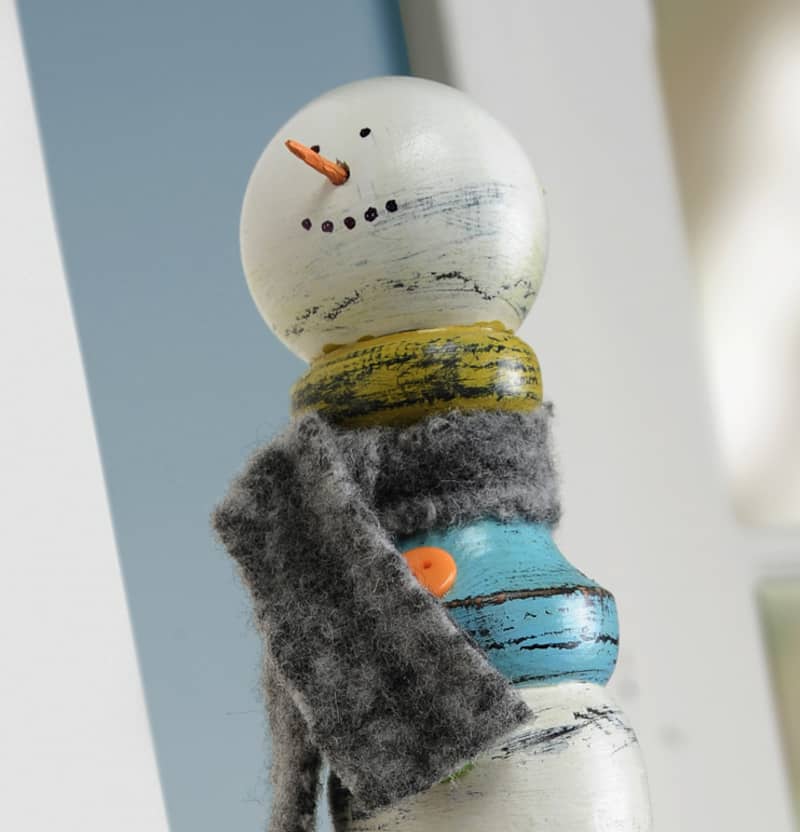 Grab a wood spindle from the hardware store or a construction site and turn it into this unique snowman craft. It's the perfect seasonal display piece!