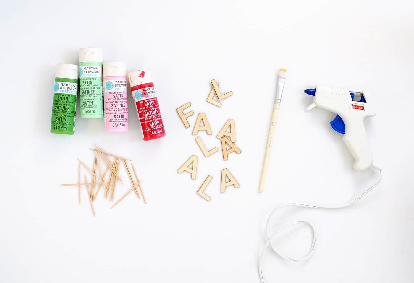 Wood letters, hot glue gun, toothpicks, paintbrush, and paint in red, green, and pink