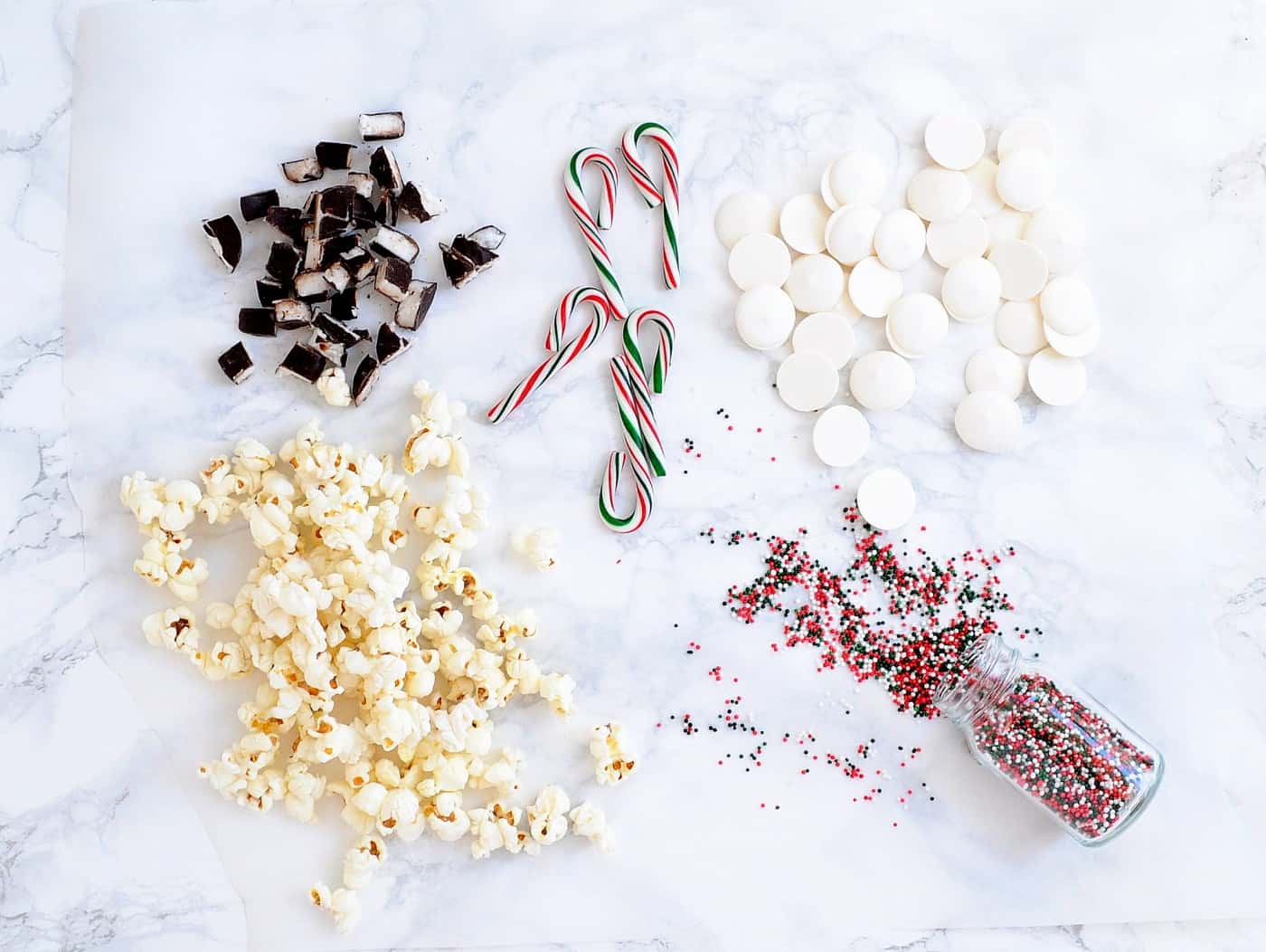 Peppermint patties, candy canes, popcorn, candy melts, and red and green sprinkles